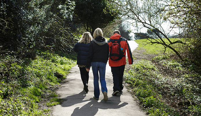 man walking with support workers