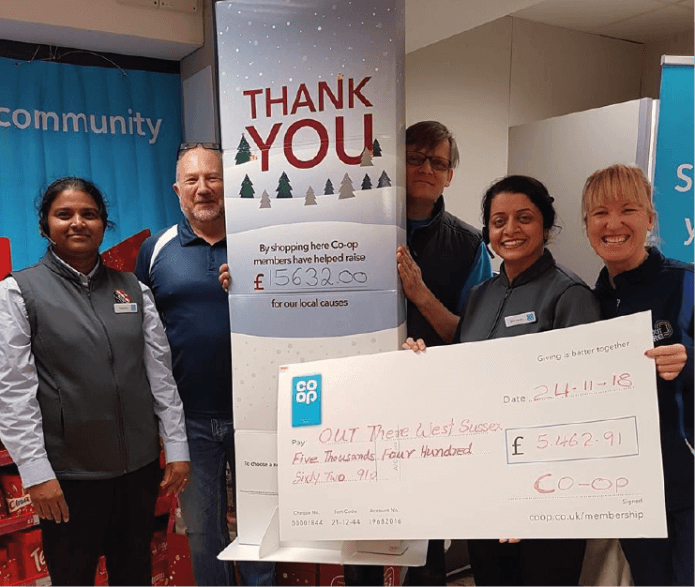 Co-op presenting Out there west Sussex with a cheque of £5,462.01