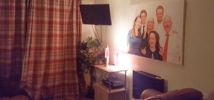 Freddie's cosy living room with a picture of his family hung on the wall