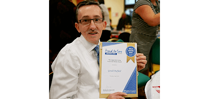 Gerald holding his Gold Wiltshire Proud to Care award