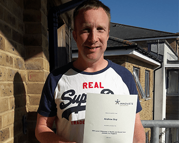 Photo of Andy Guy with his certificate