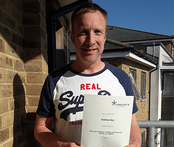 Photo of Andy Guy with his certificate