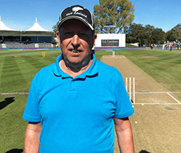 Steve Thomas stood on cricket field